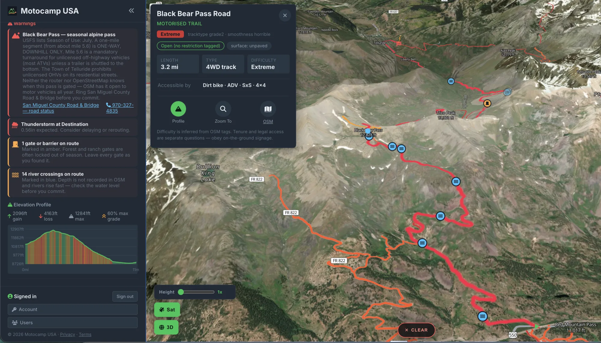 Black Bear Pass, Colorado in Motocamp USA: the trail card rates it Extreme 4WD track, the sidebar warns it is a seasonal alpine pass with a one-way downhill-only mile and gives the county road office's phone number, and the elevation profile shows 2,096 feet of gain to 12,841 feet at up to 60 percent grade.