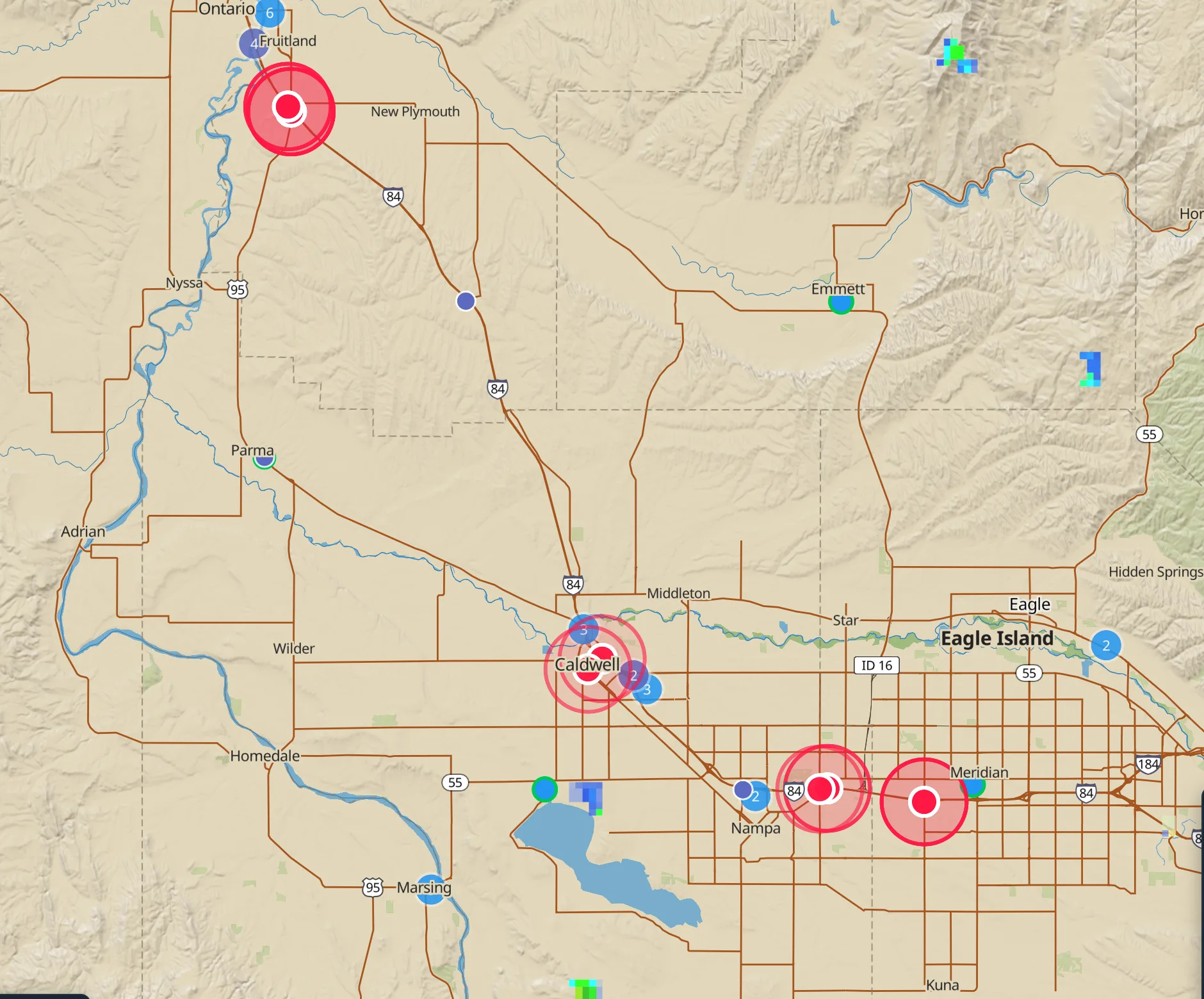 Four live road closures on the topographic map around Boise, Idaho, each a red dot inside a shaded circle marking the reported closure, from the Idaho Transportation Department feed.